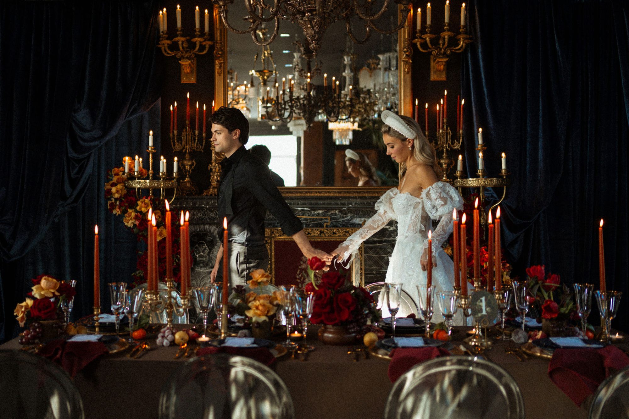 A couple lighting the candles on a long reception table at Manoir Blackswan